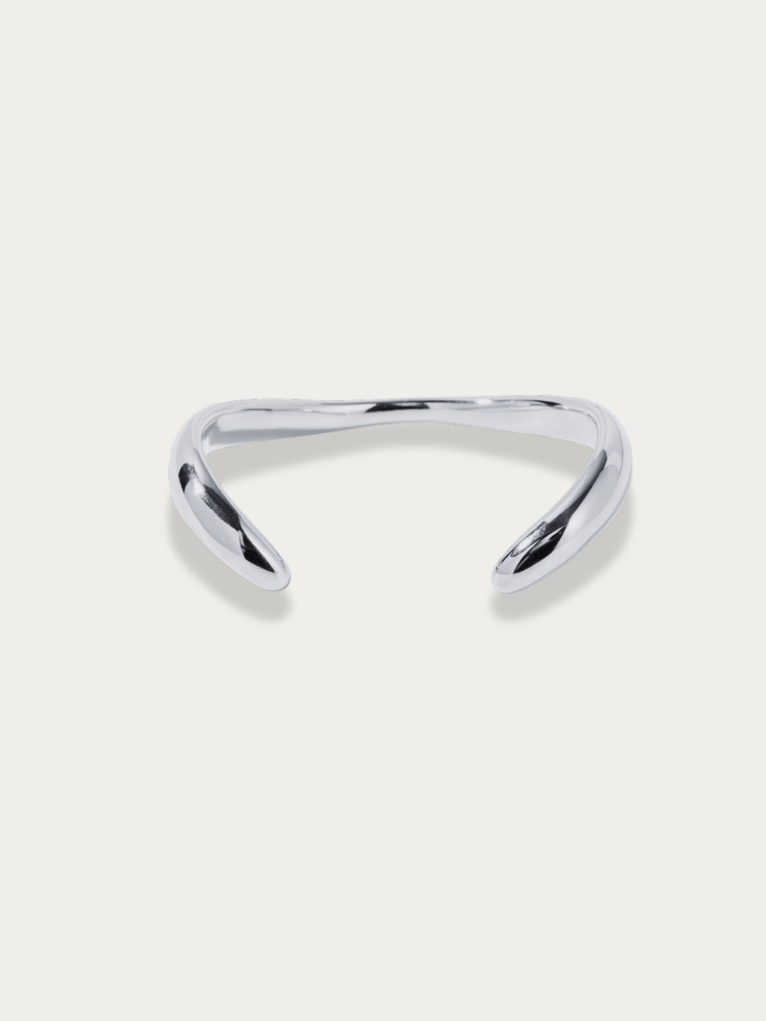 Flow Curved Bangle in silver titanium with fluid sculptural curves, studio hero shot