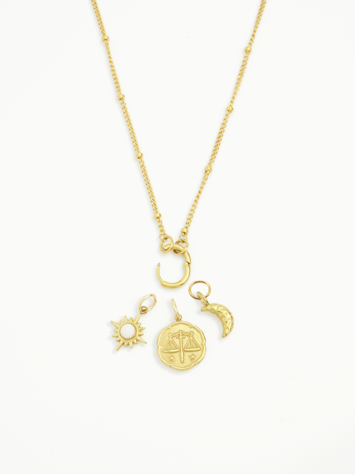 Gold sunbeam charm symbolic jewellery