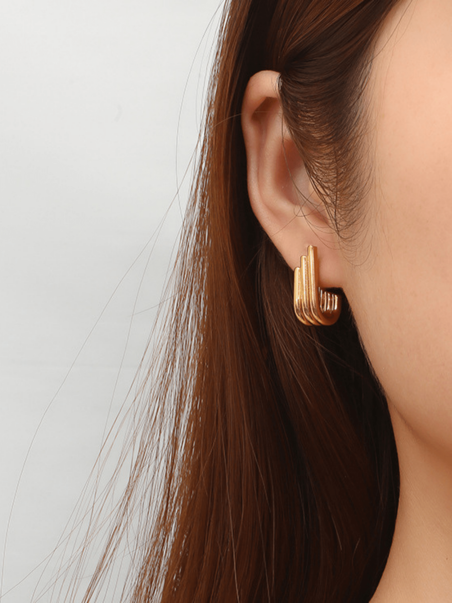 Goldie J-Curve Hoops worn on ear