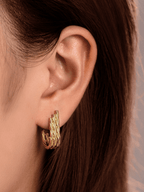 Close-up of twisted cable texture on three parallel strands of Goldie Twist J-Curve Hoop Earrings