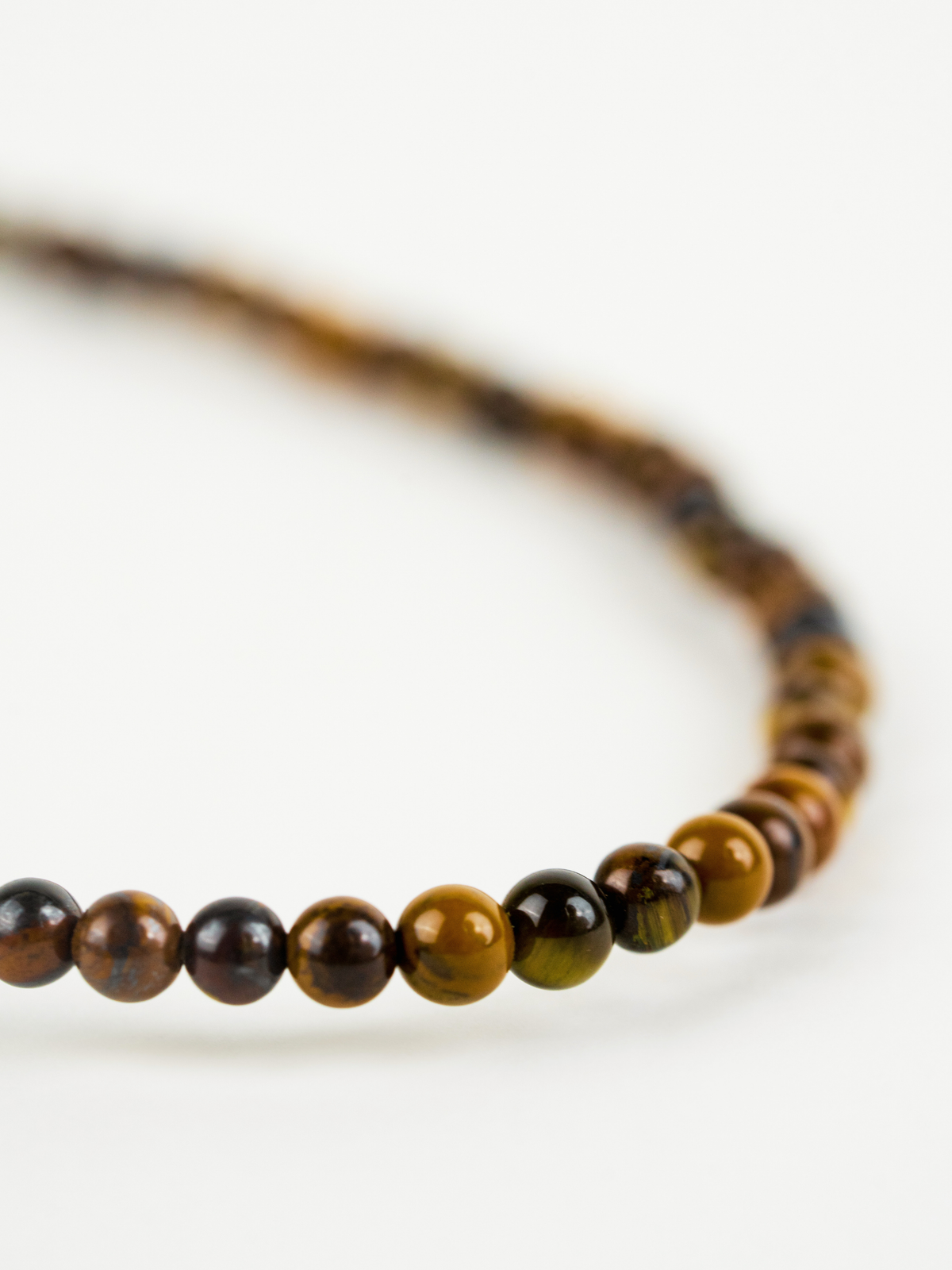 Close-up of natural tiger's eye beads on Grounded Necklace