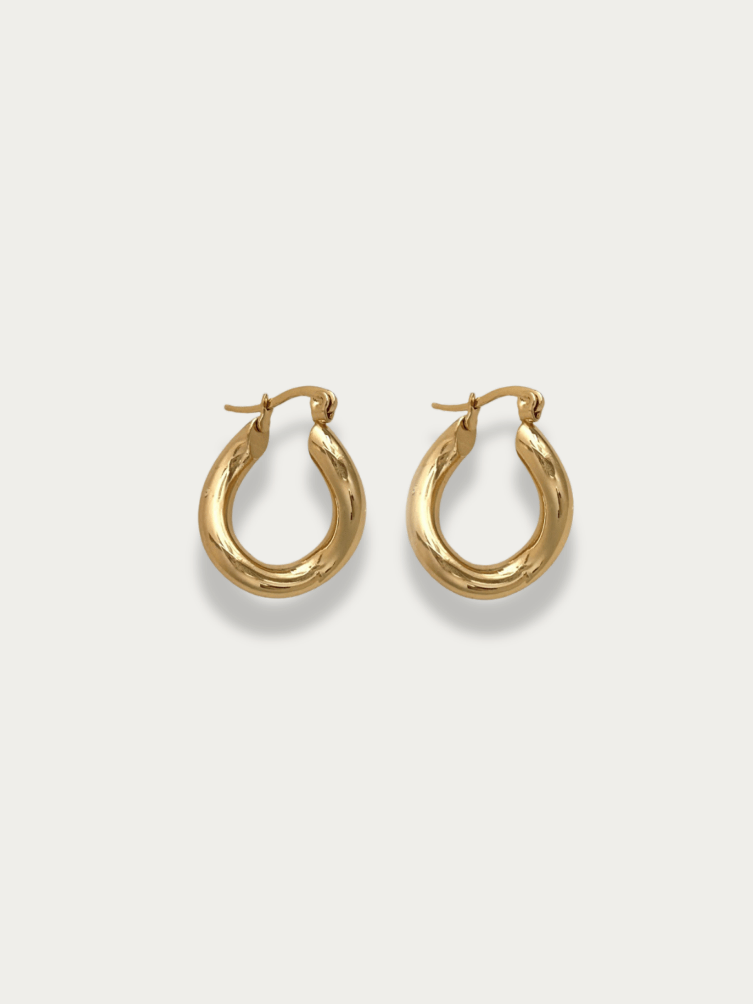 Gwenna Geo Drop Hoops pair in gold titanium with sculptural teardrop silhouette, studio hero shot