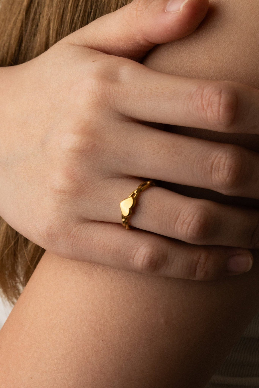 Close-up of puffy 3D heart at top of Heart Chain Ring, high-polish gold stainless steel