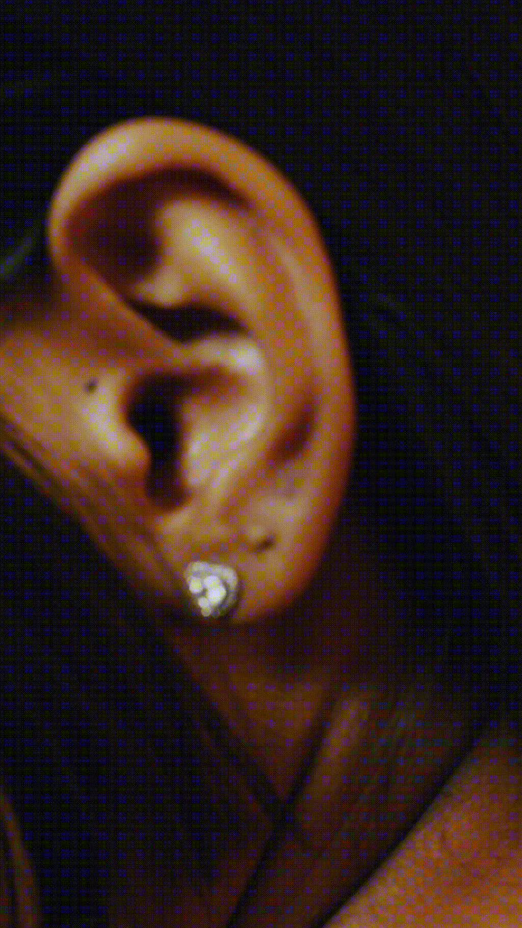 Close-up of EMERY heart-shaped silver studs with pavé detail