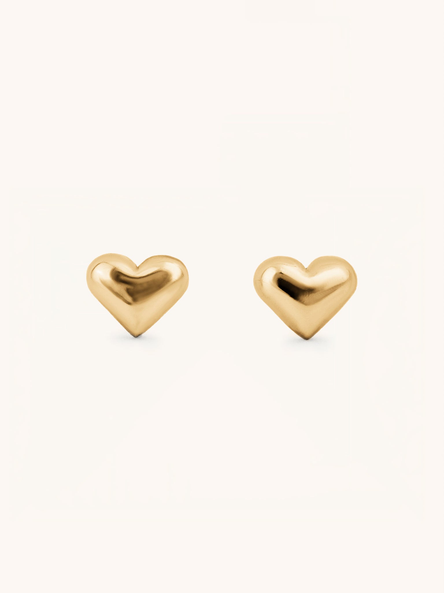 Heart Stud Earrings gold tone stainless steel, puffy 3D heart studs, product flatlay