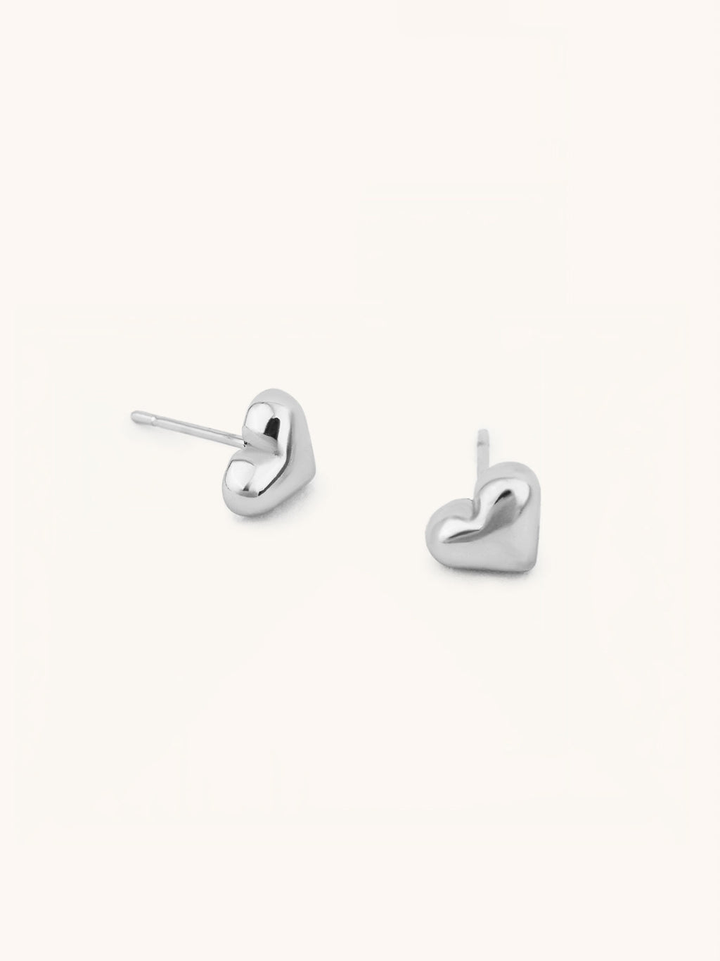 Heart Stud Earrings silver tone stainless steel, puffy 3D heart studs, product flatlay