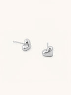 Heart Stud Earrings silver tone stainless steel, puffy 3D heart studs, product flatlay