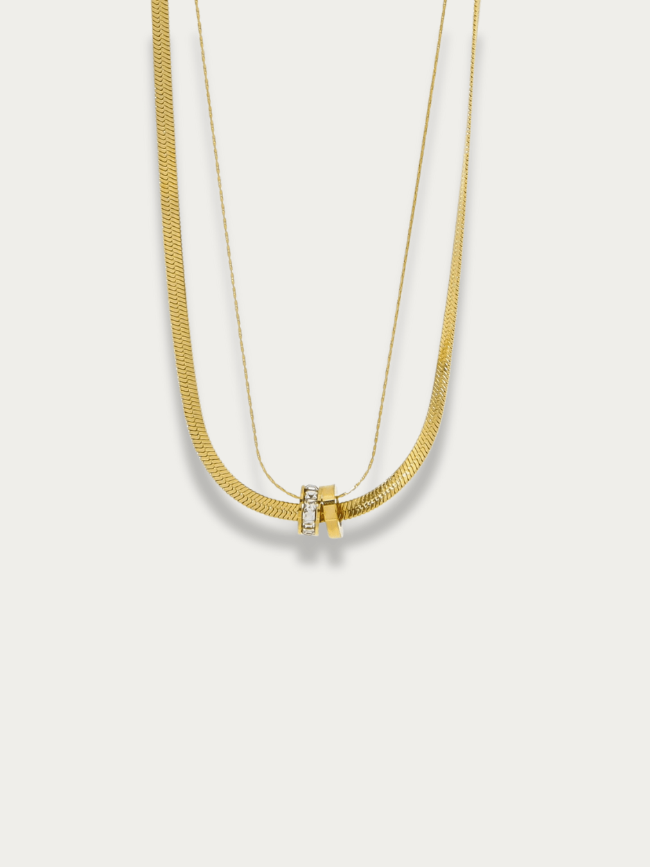 Herringbone Layered Rolling Stones Necklace gold tone titanium, herringbone and fine chain with CZ rolling rings pendant, product flatlay