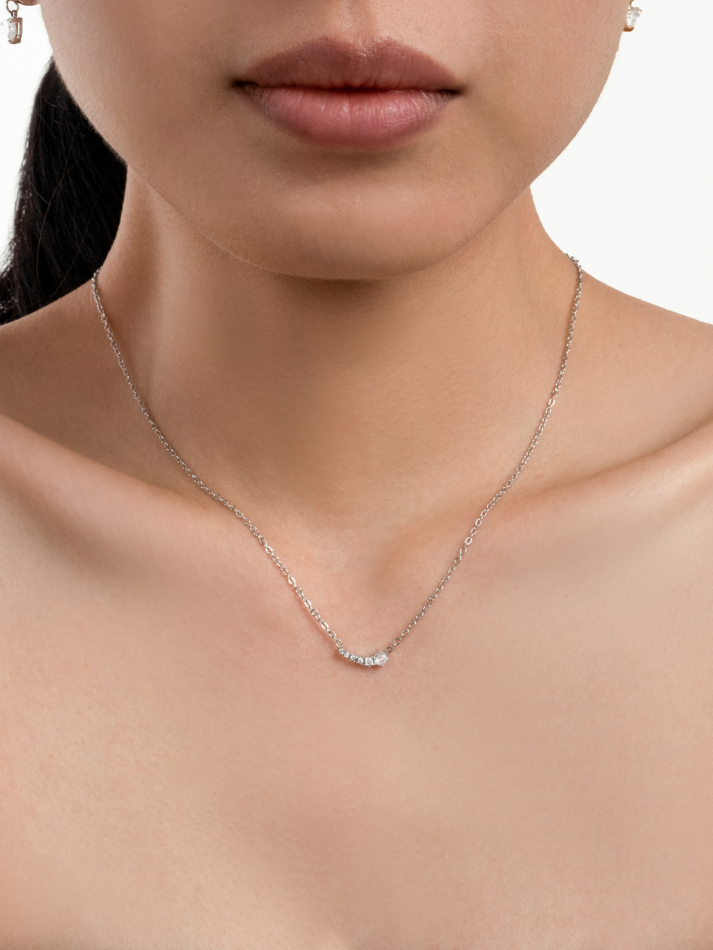 Jupiter Cascading Spark Necklace in silver colour worn on neckline