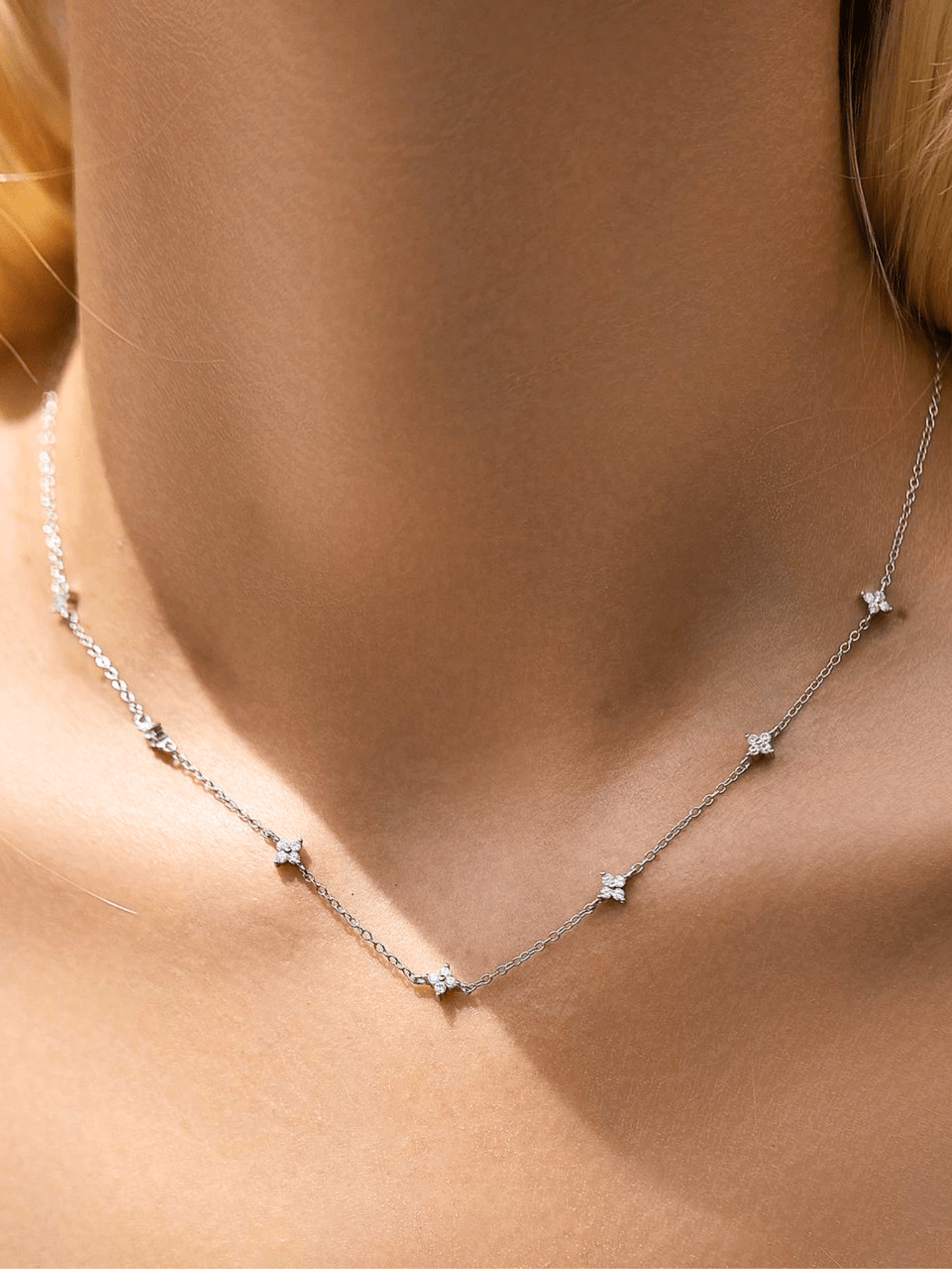 Model wearing LAUREL Floral Diamonds Necklace in silver at the collarbone