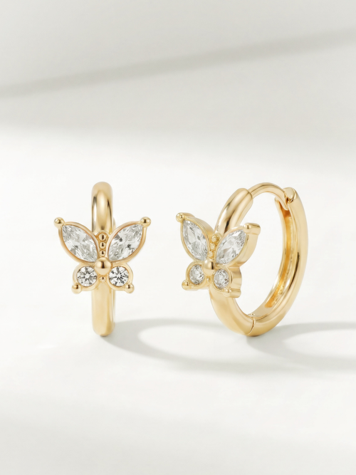 Leia Butterfly CZ Huggie Earrings gold tone stainless steel, butterfly motif with CZ stones, product flatlay