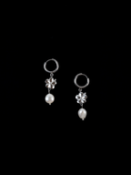 Close-up of hibiscus motif and freshwater pearl on hoop earring