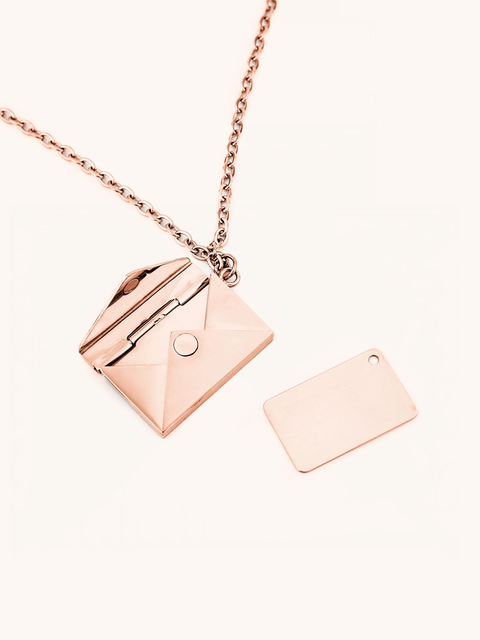 Love Letter Pendant Necklace in rose gold tone titanium, envelope locket open showing inner engraving tag