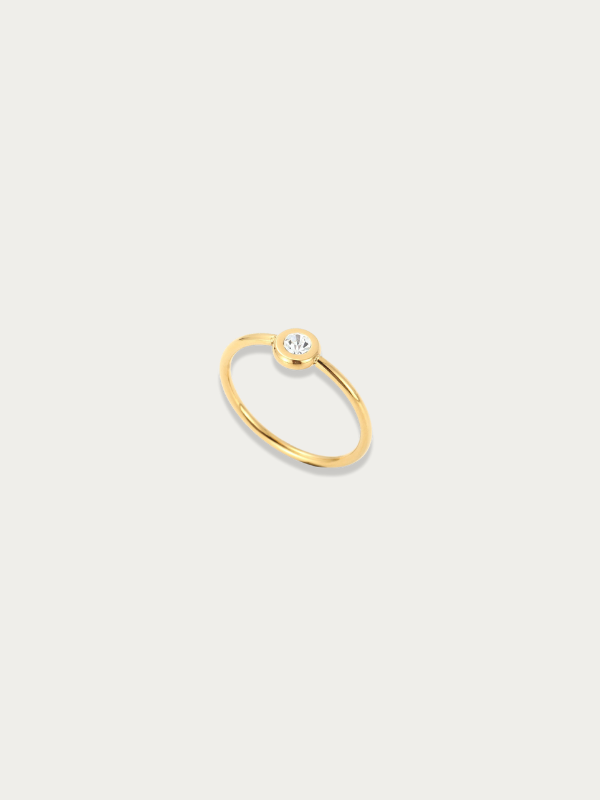 Lune Band Ring gold tone titanium, slim band with single bezel-set CZ stone, product flatlay