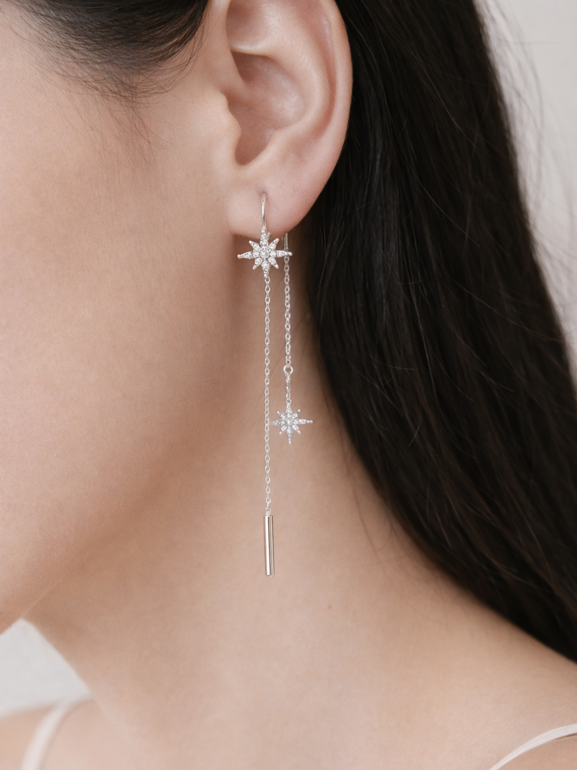 Close-up of eight-point star motif with precision-set moissanite stones on Lyre earrings