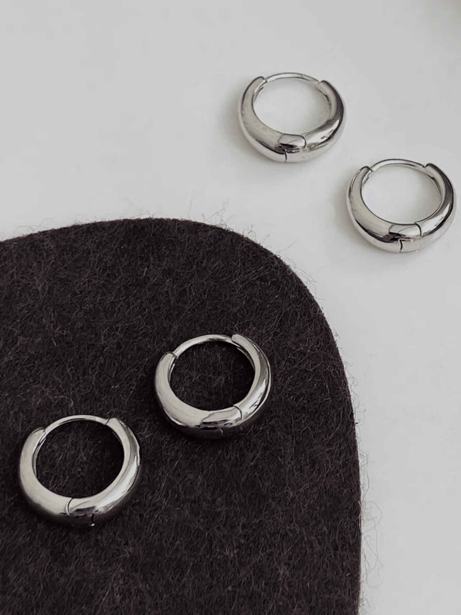 Mason Mini Arc Hoops flatlay in gold and silver colourways