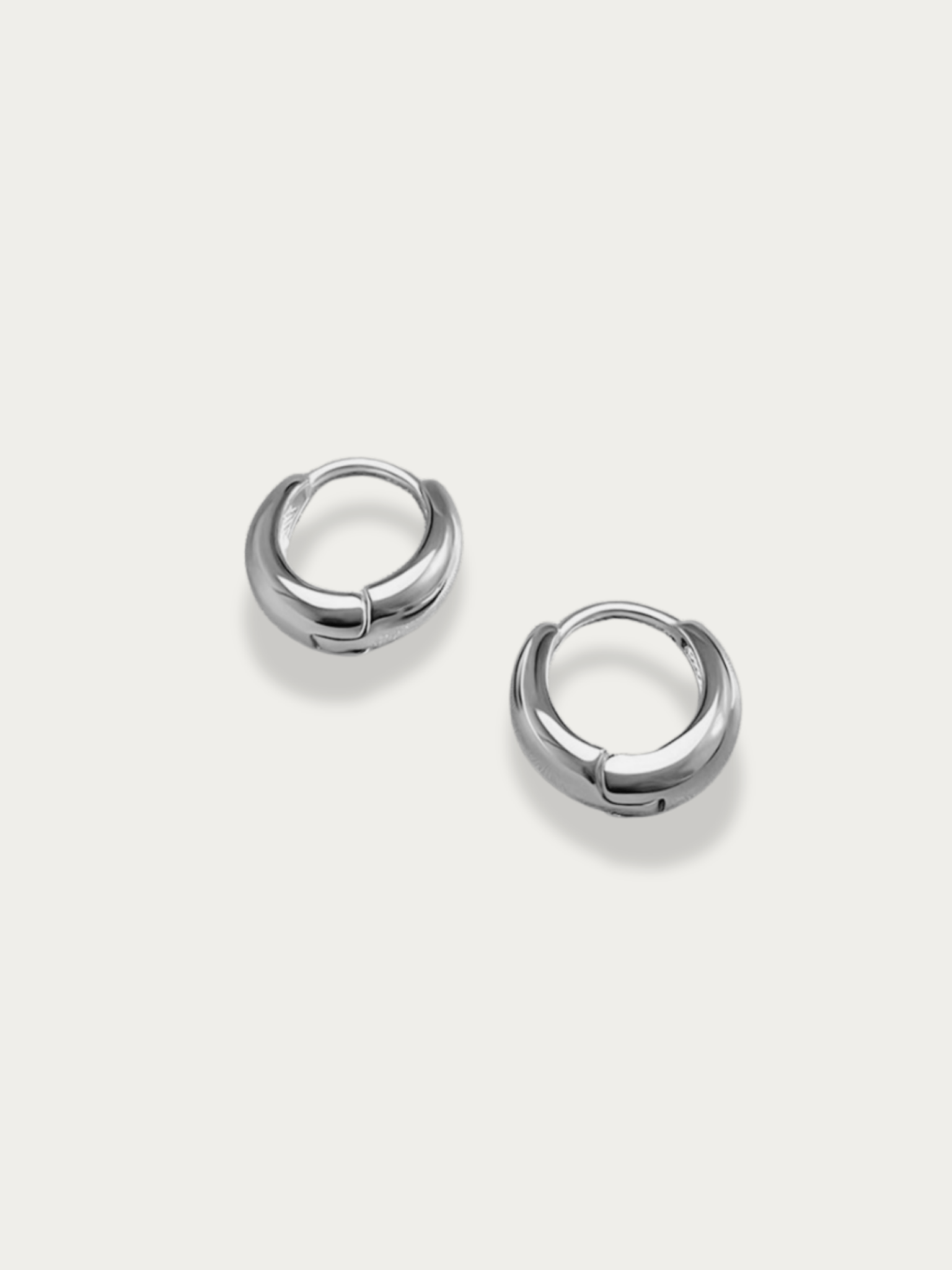 Mason Mini Arc Hoops worn on ear, silver finish