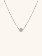 Mini Flower Engravable Necklace silver tone titanium, flat five-petal flower pendant on fine cable chain, product flatlay