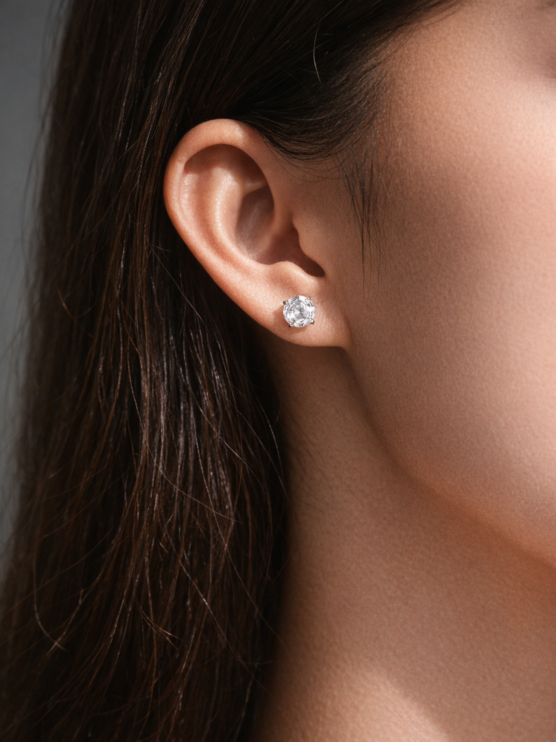 Close-up of an ear wearing a rose cutdiamond earring with blurred background