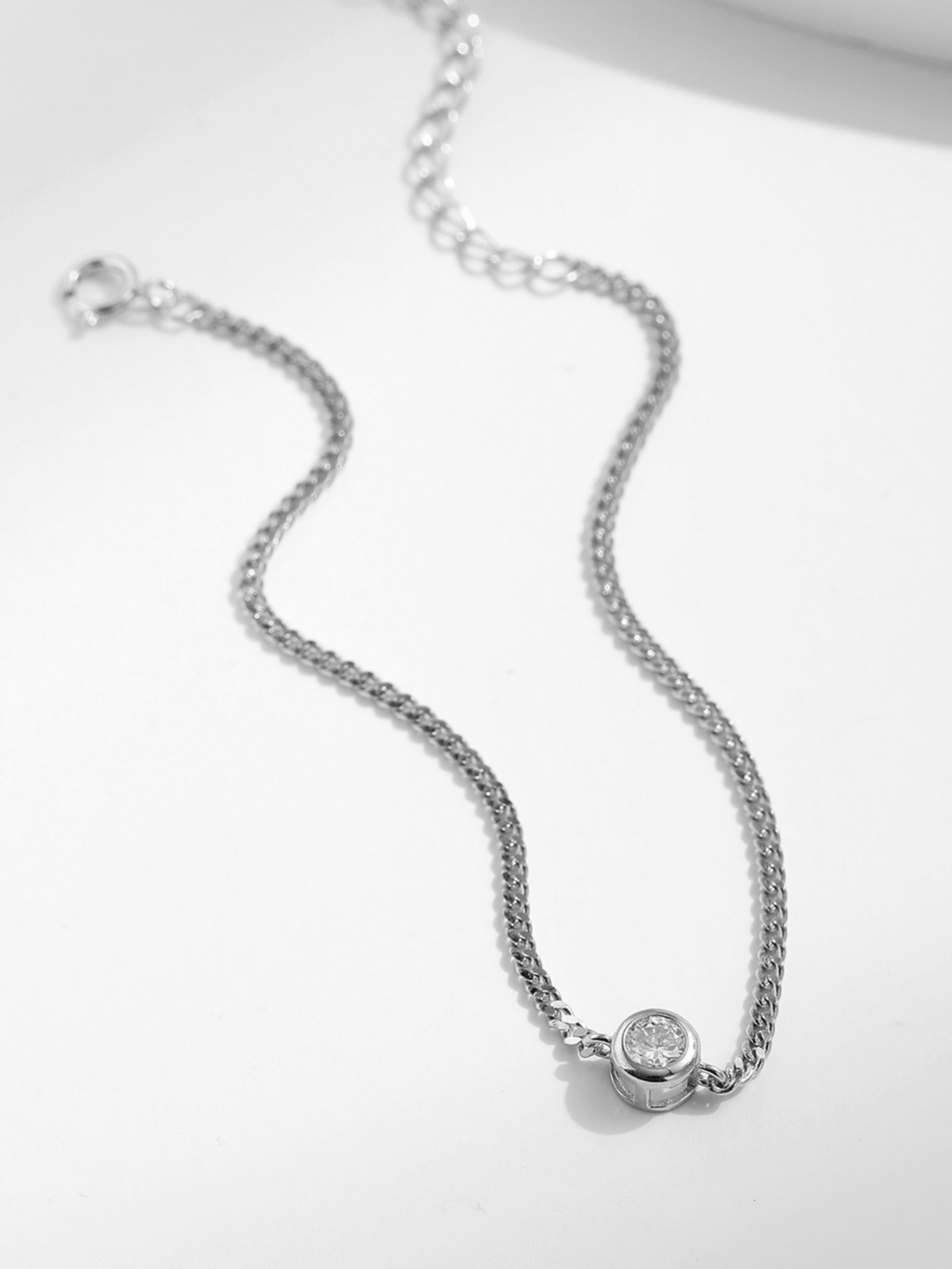 Minimalist silver bracelet with moissanite solitaire