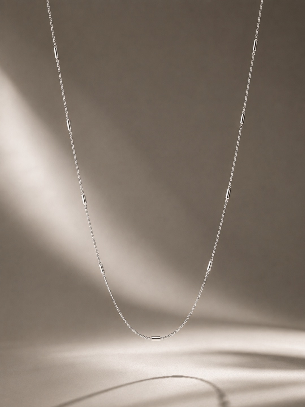 Angled view of Minimalist Tube Link Necklace showing chain construction