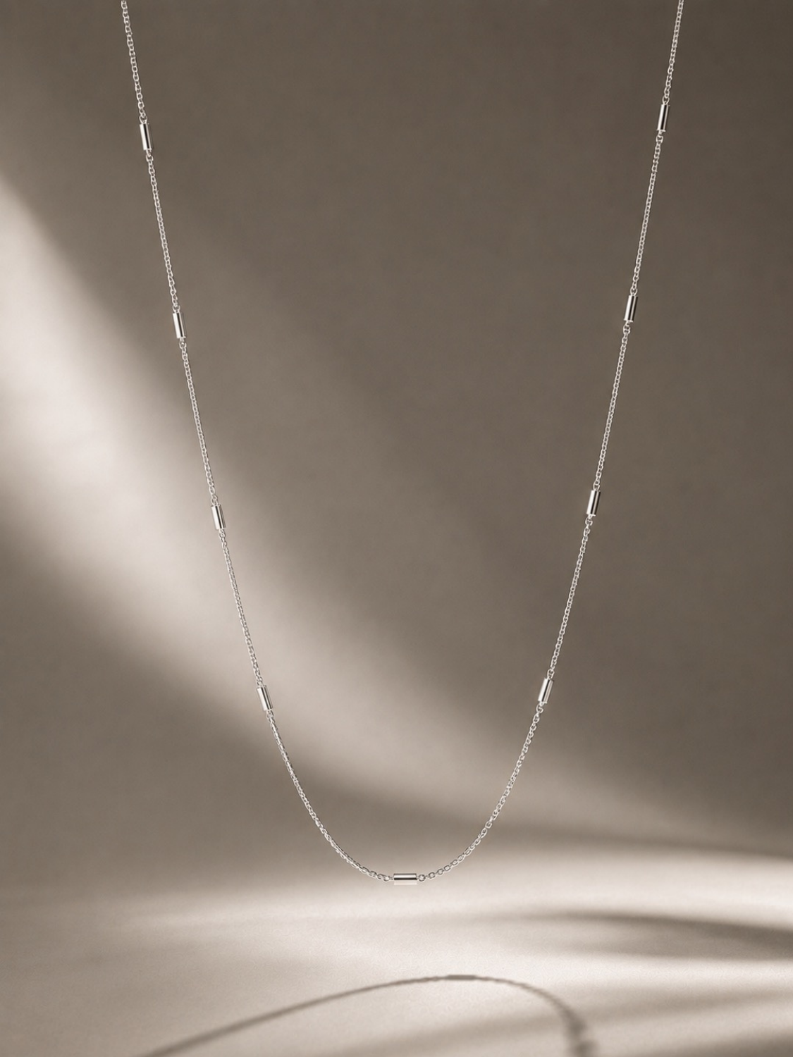 Angled view of Minimalist Tube Link Necklace showing chain construction