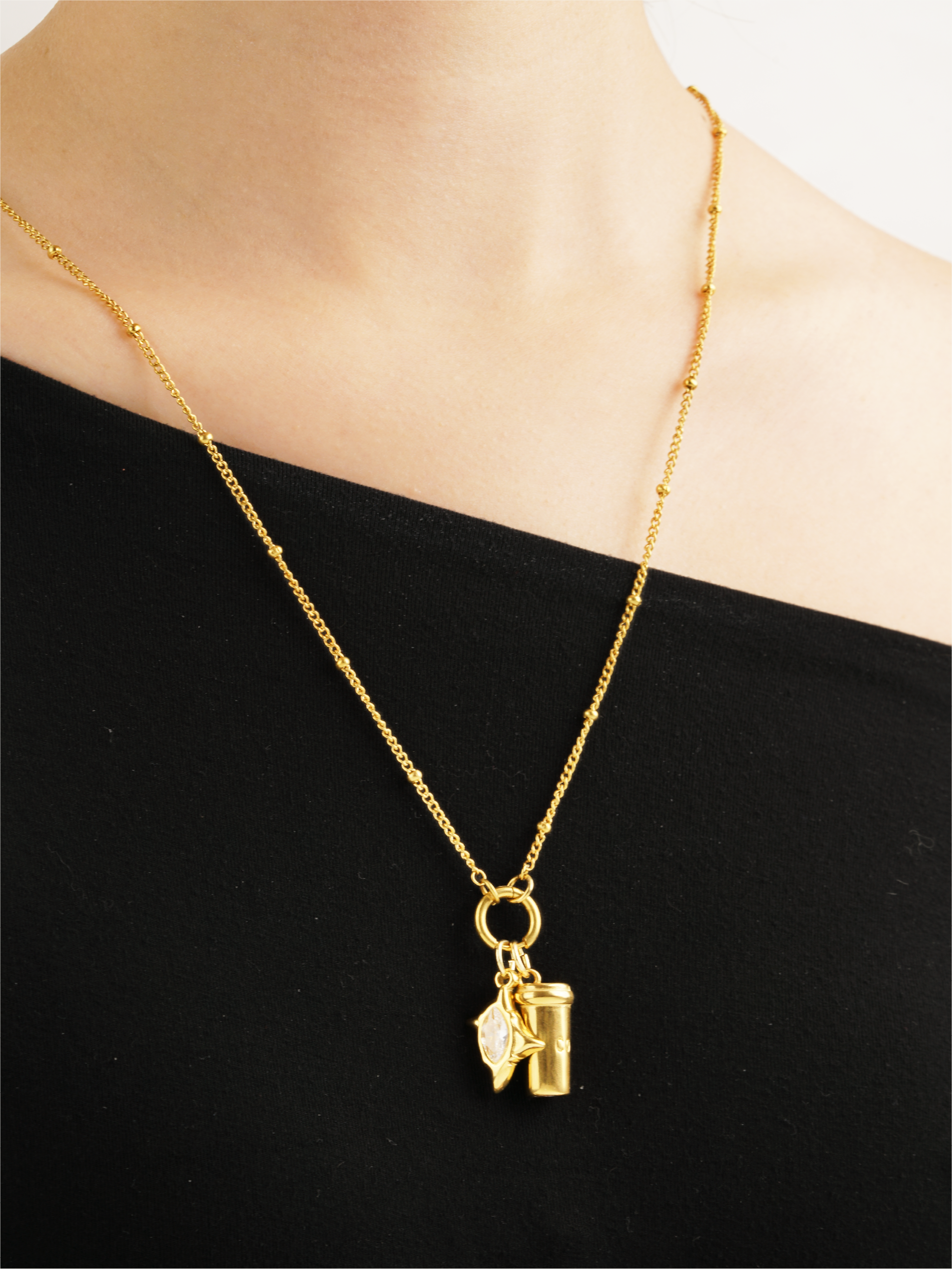minimalist coffee charm necklace worn by model