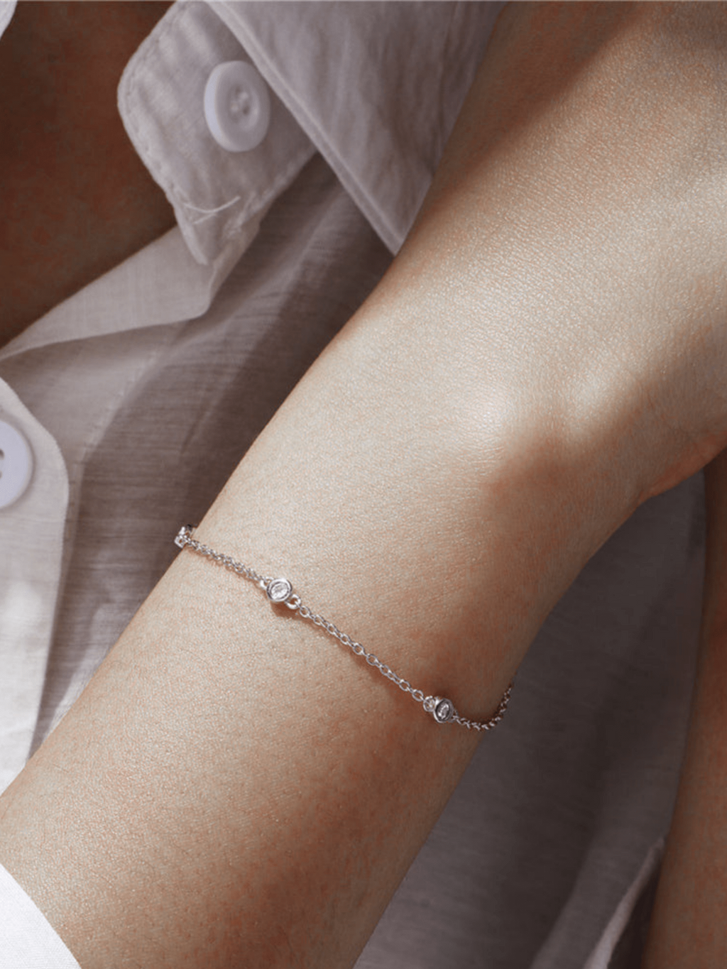 ALEXIS bracelet stacked with other minimalist bracelets