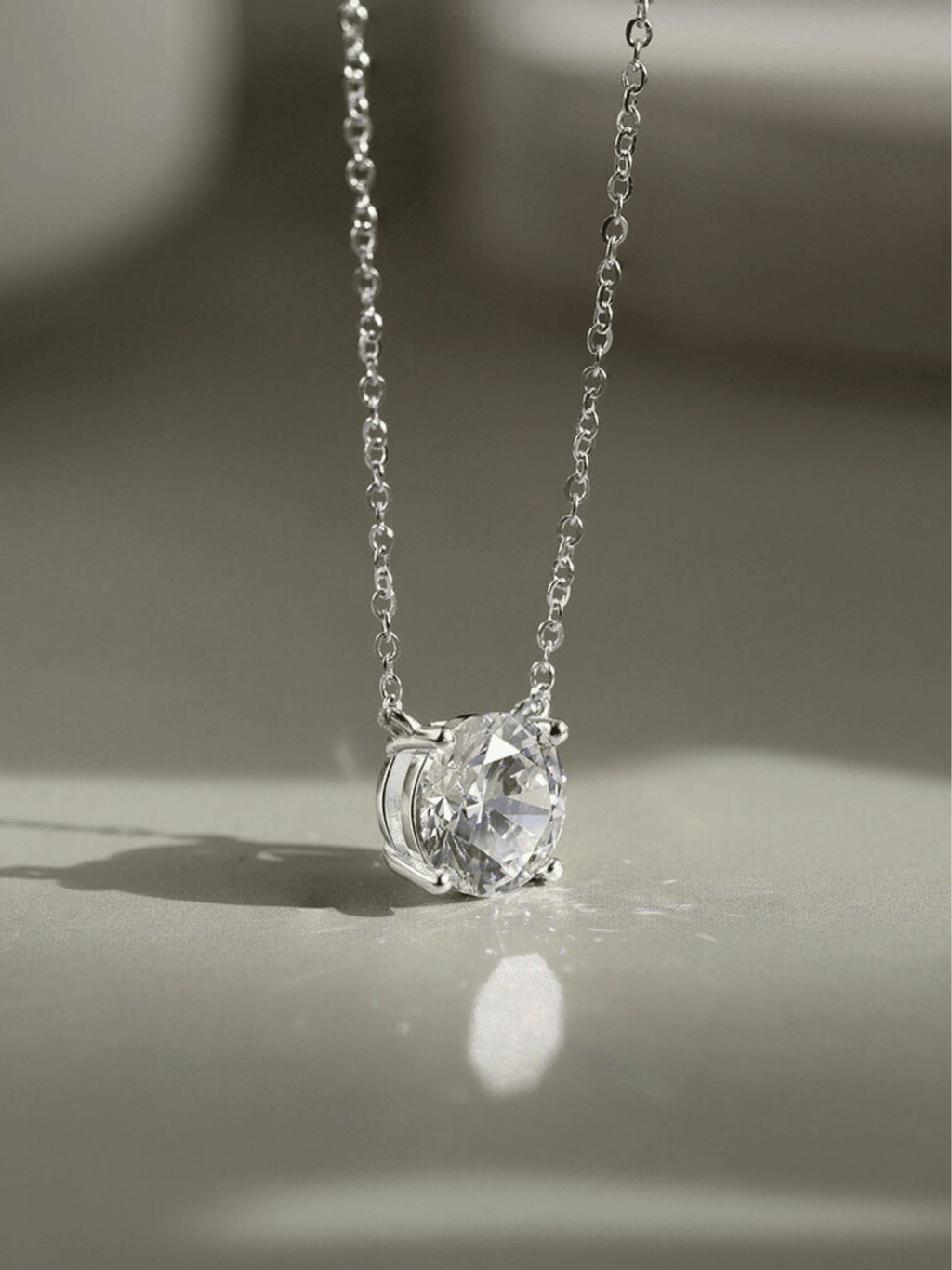 Close-up of 1ct round brilliant moissanite on MNML Amélie Necklace — fire and brilliance detail