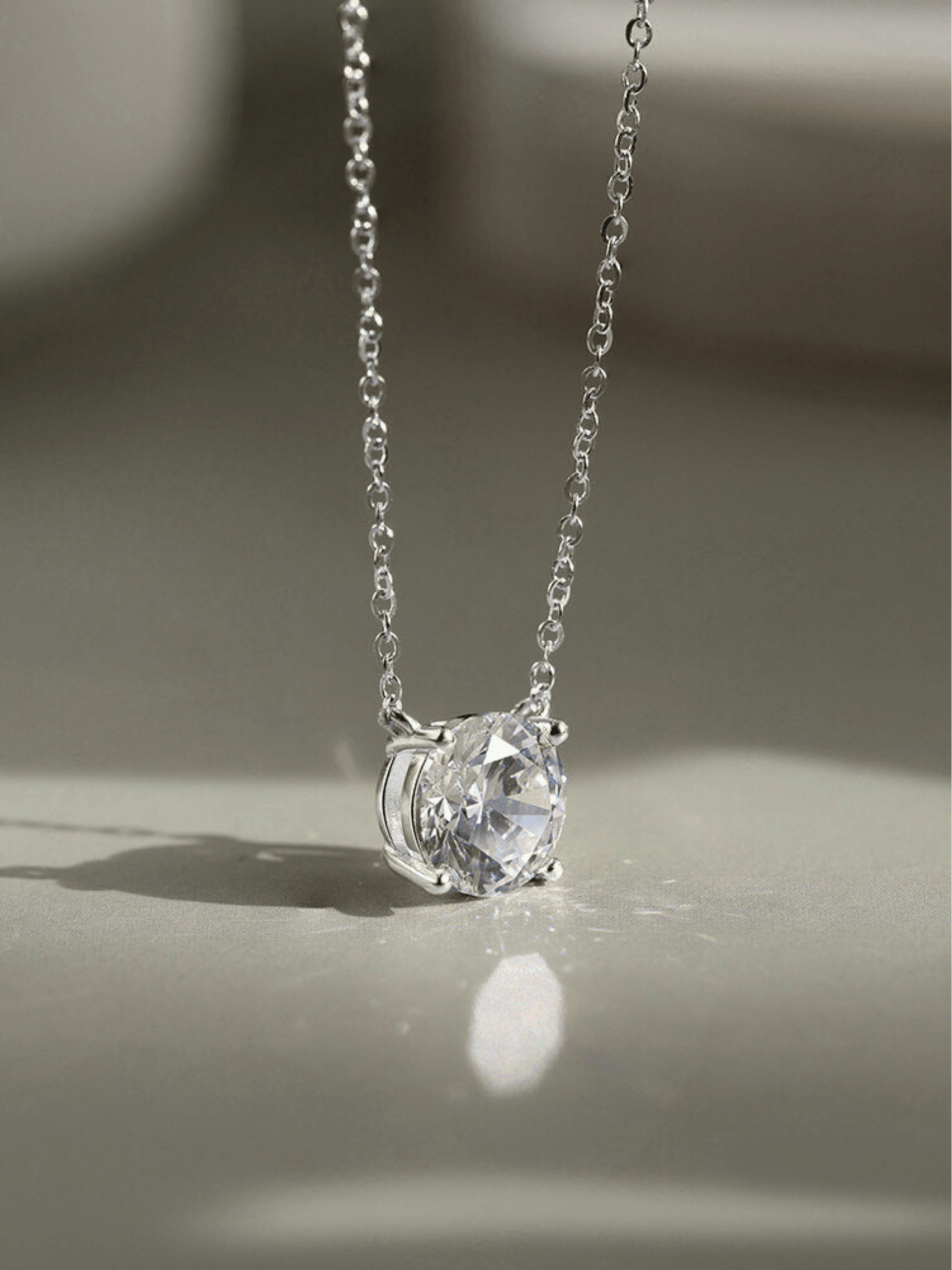 Close-up of 1ct round brilliant moissanite on MNML Amélie Necklace — fire and brilliance detail