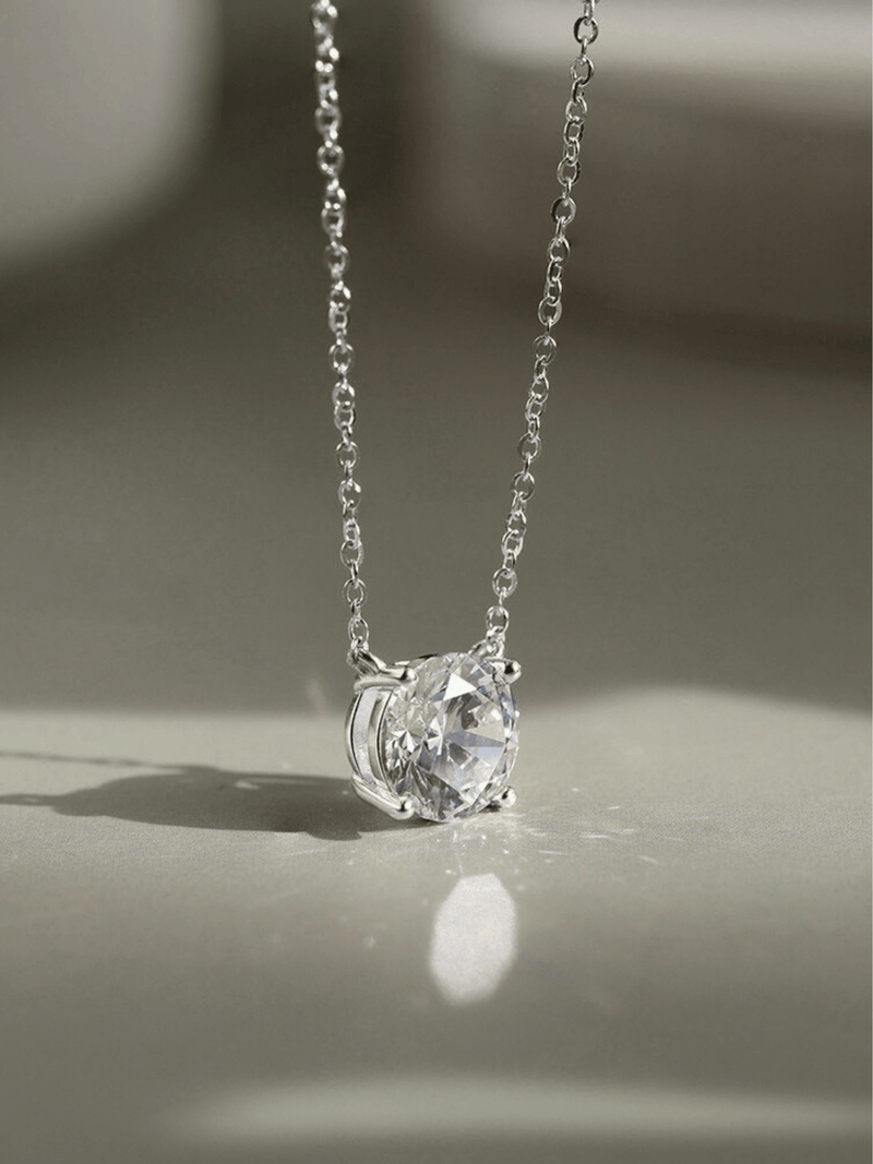 Close-up of 1ct round brilliant moissanite on MNML Amélie Necklace — fire and brilliance detail