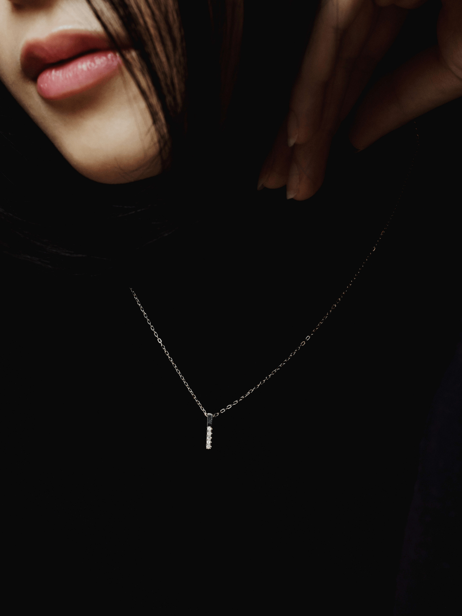 Close-up of vertical bar pendant on ARDEN necklace