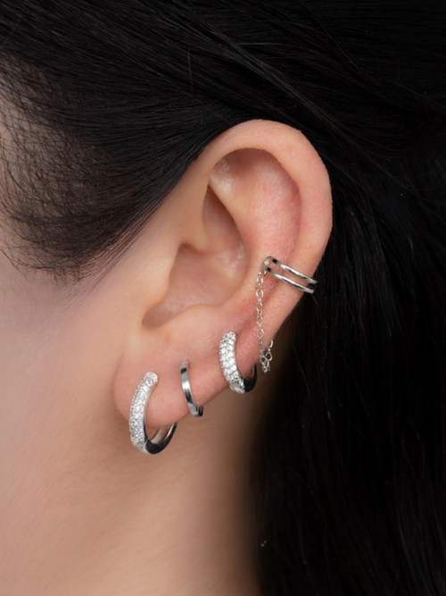 Ear curation styling with MNML Ari Chain Drop Ear Cuff layered with studs and huggies in silver