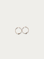 Aria Knot Hoop Earrings in rose gold titanium on a white background.