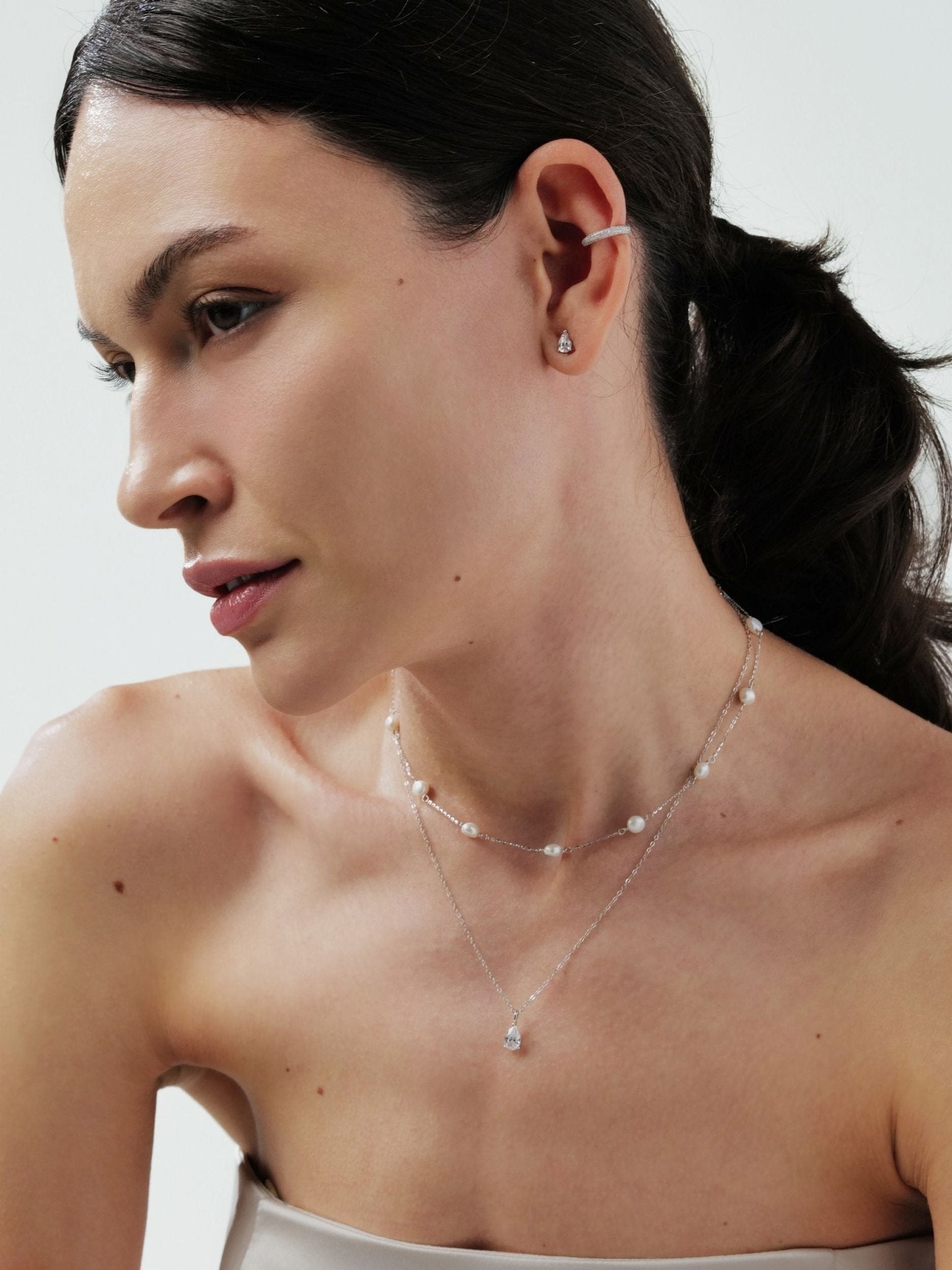 Aurélie necklace layered with other minimalist chains