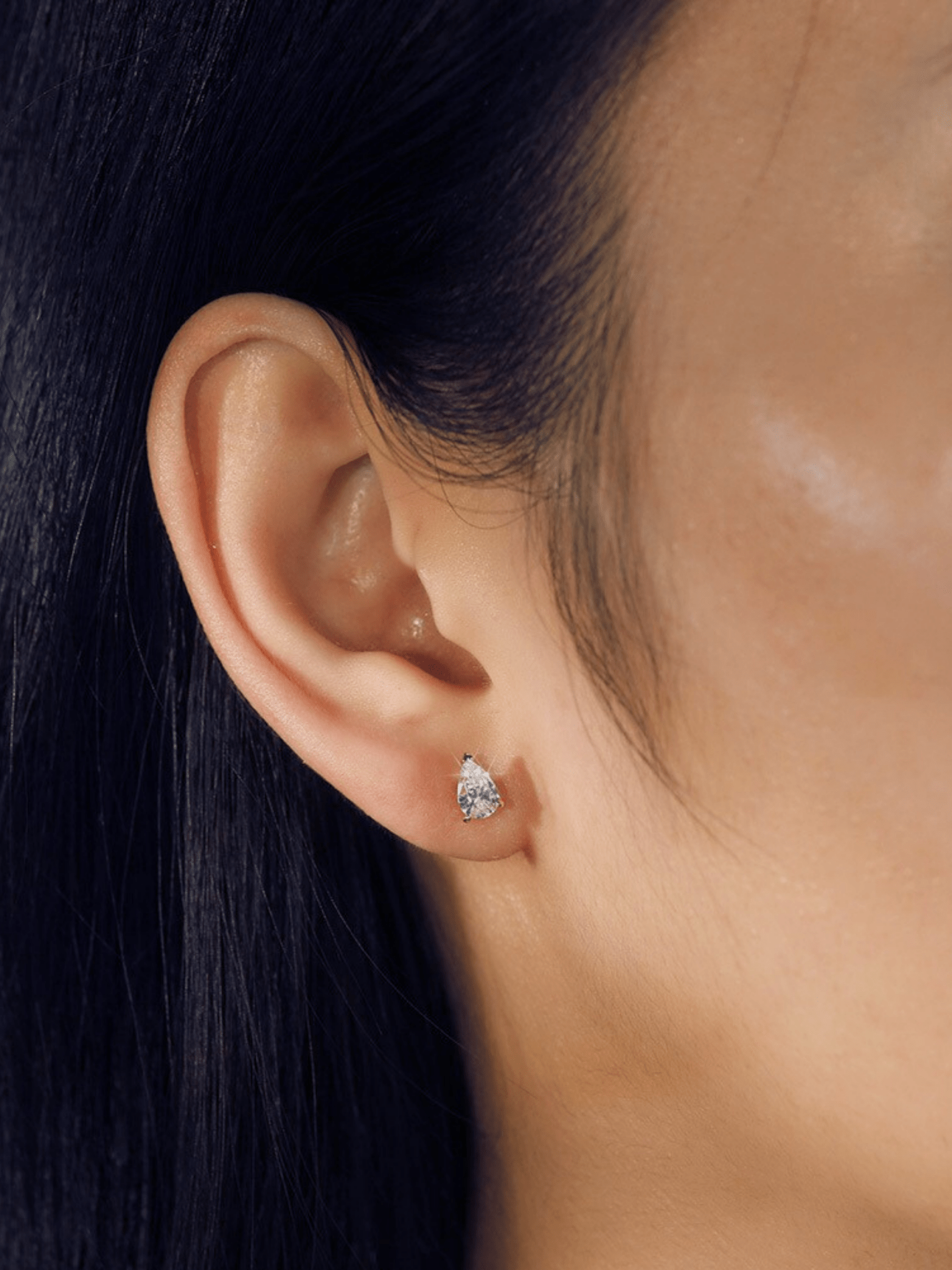 Aurélie teardrop stud earring worn on the ear
