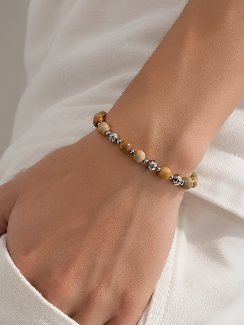 Canyon Bead Bracelet worn on the wrist with a white sleeve