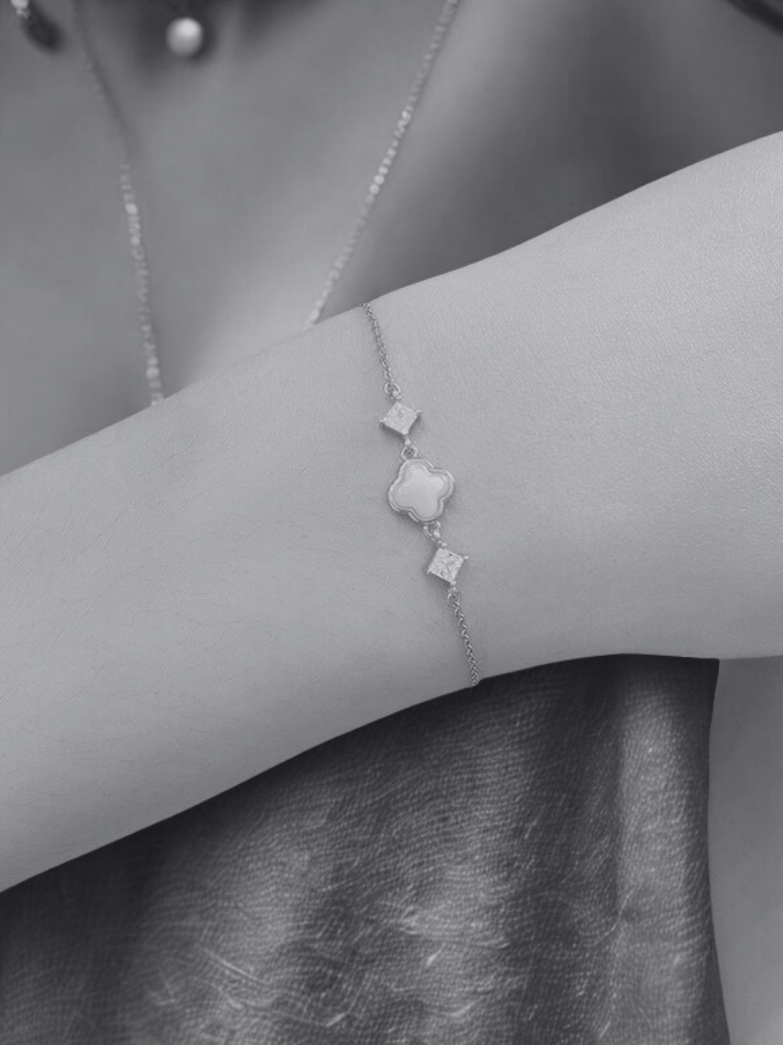 Close-up of nephrite jade clover on Celine bracelet