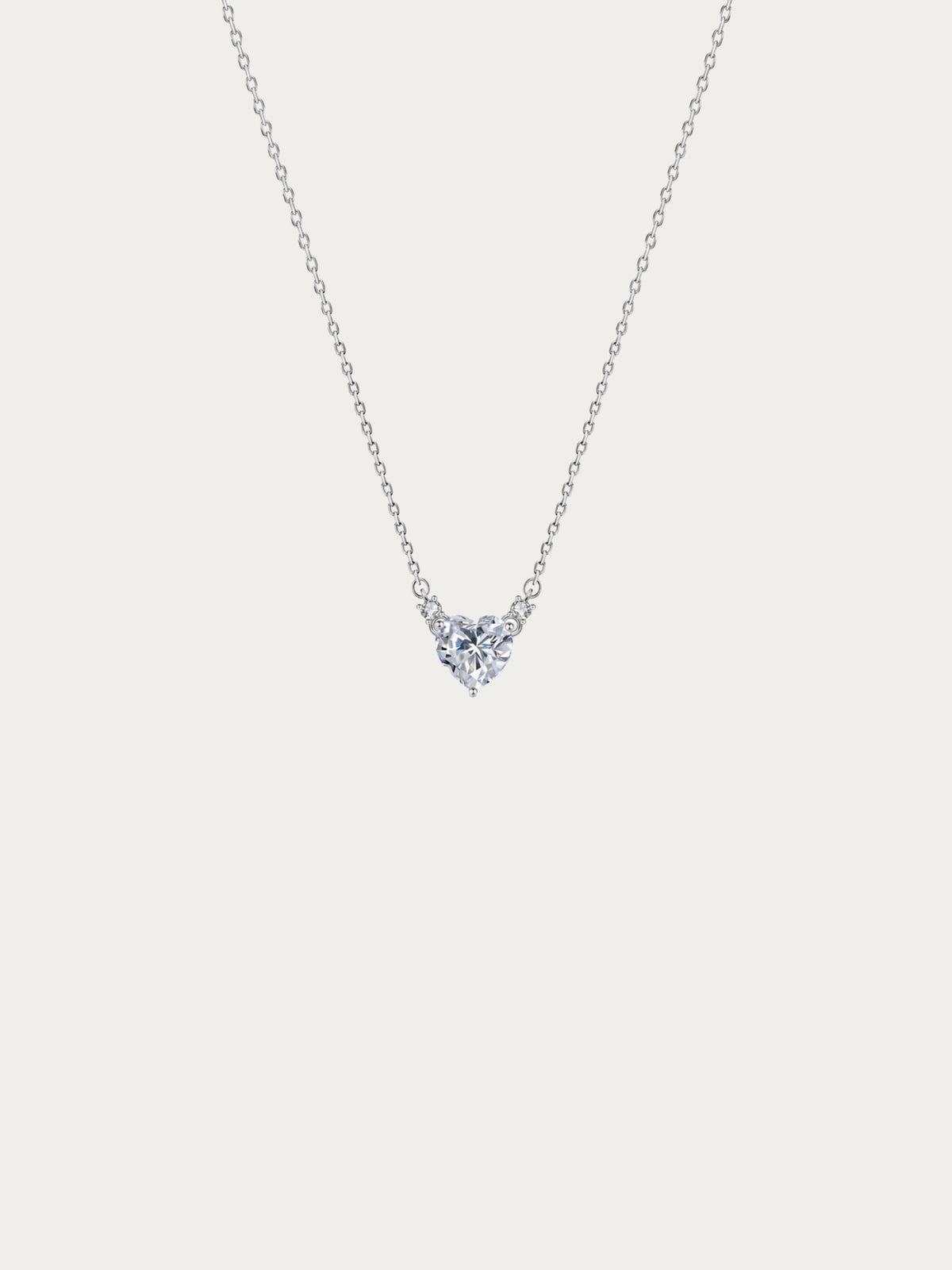 Cherish Heart Spark Necklace with a heart-cut cubic zirconia between two accent stones on 925 sterling silver, front view