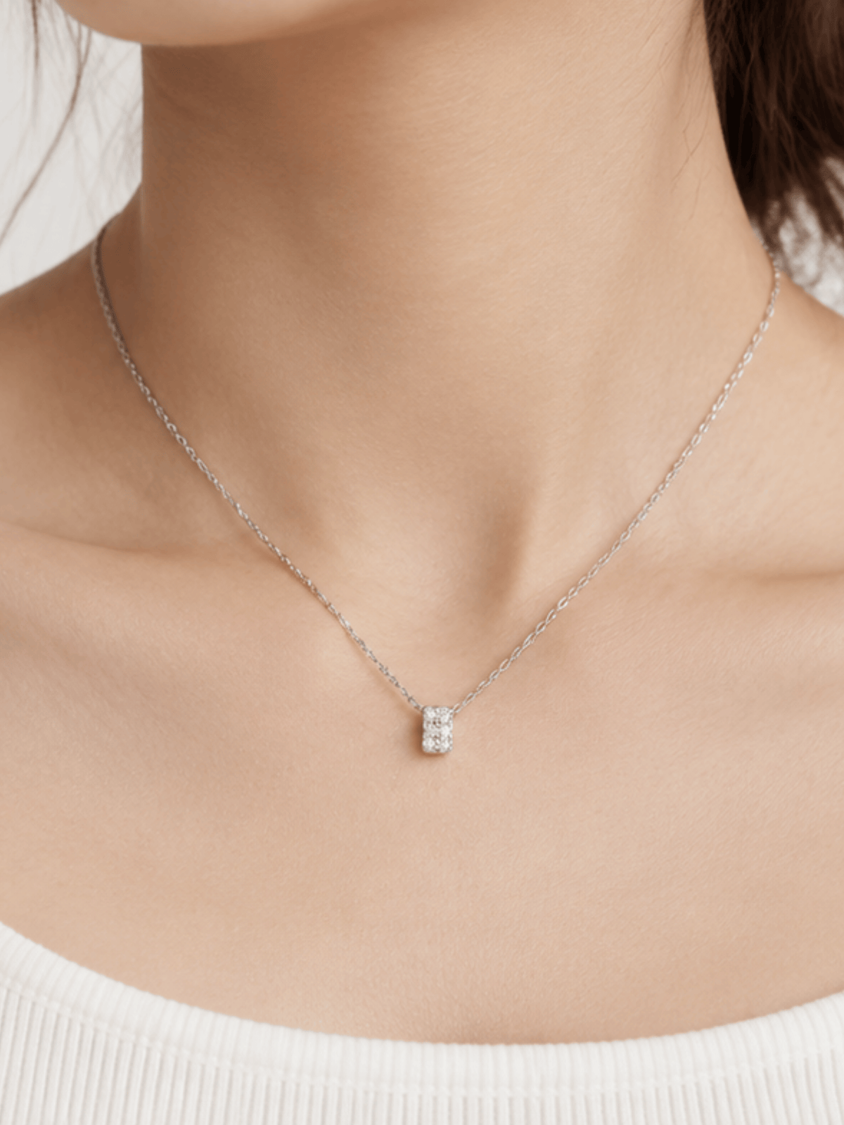 Silver-tone Cielo pendant necklace worn at the base of the neck