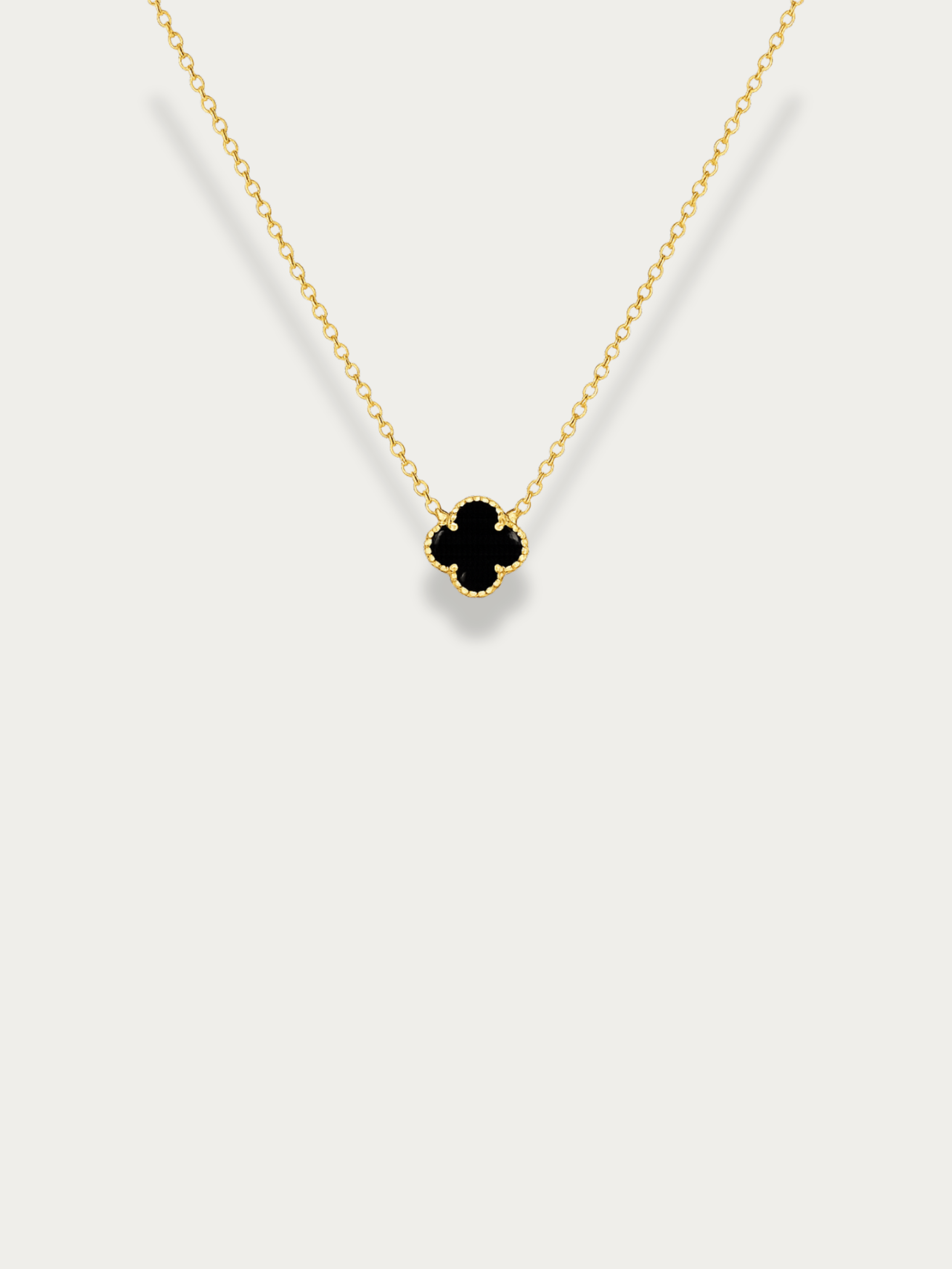 Close-up of black enamel clover on MNML Clover Duo Necklace — bold contrast titanium detail