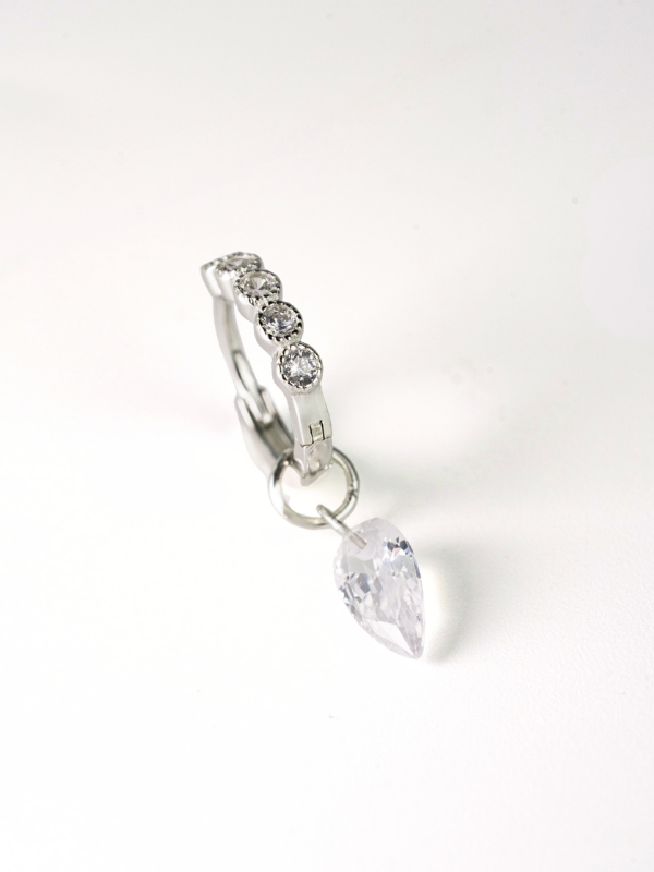 Close-up of suspended clear prism stone on MNML Cora 925 silver hoop — light-catching drop detail