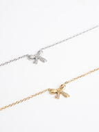 MNML Delicacy Bow Pendant Necklace in silver and gold flat lay — titanium bow jewelry Malaysia