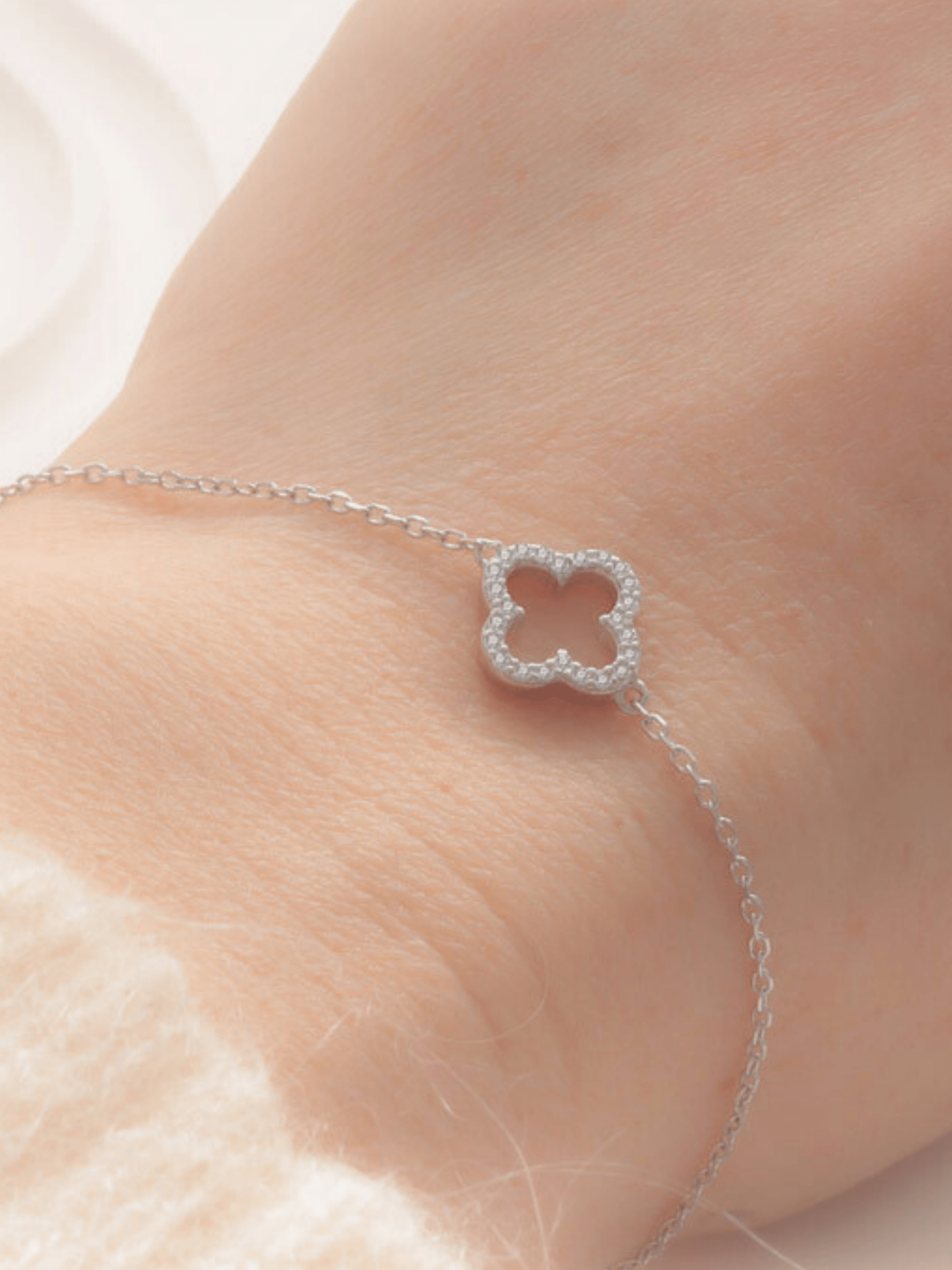 Close-up of hollow clover pendant on Élise bracelet