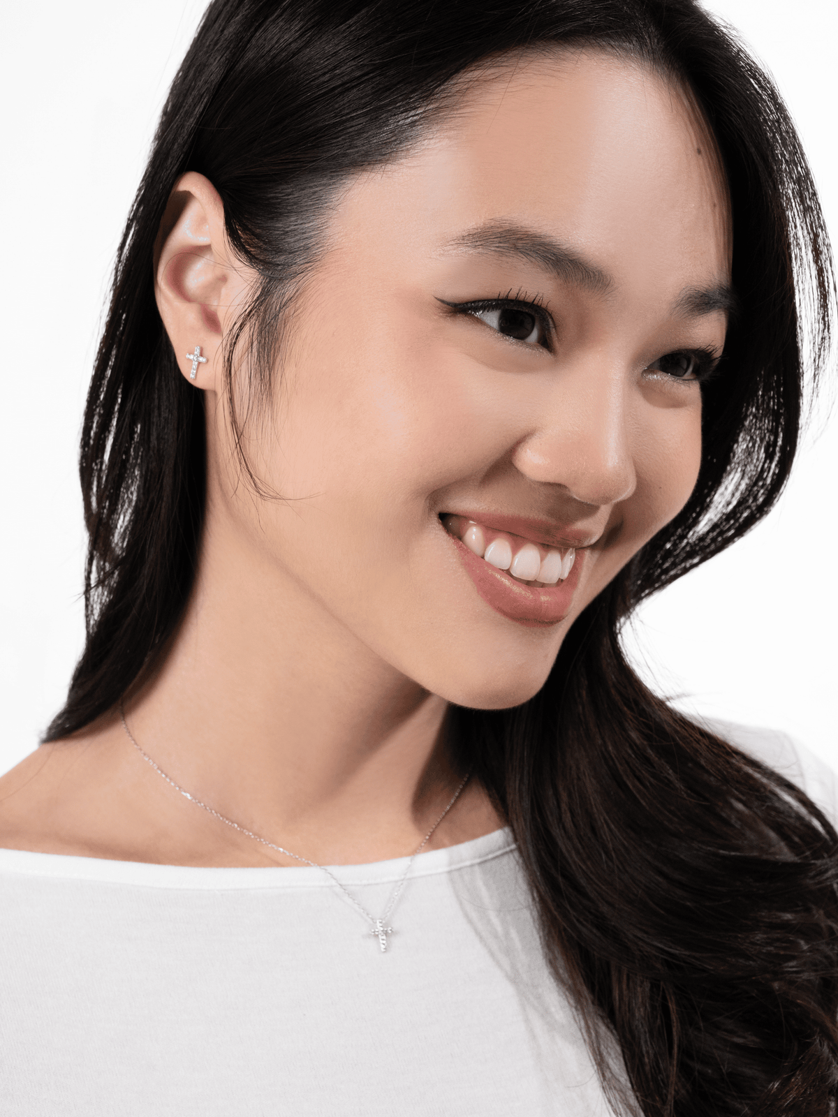 Elowen pavé cross stud worn on the ear lobe