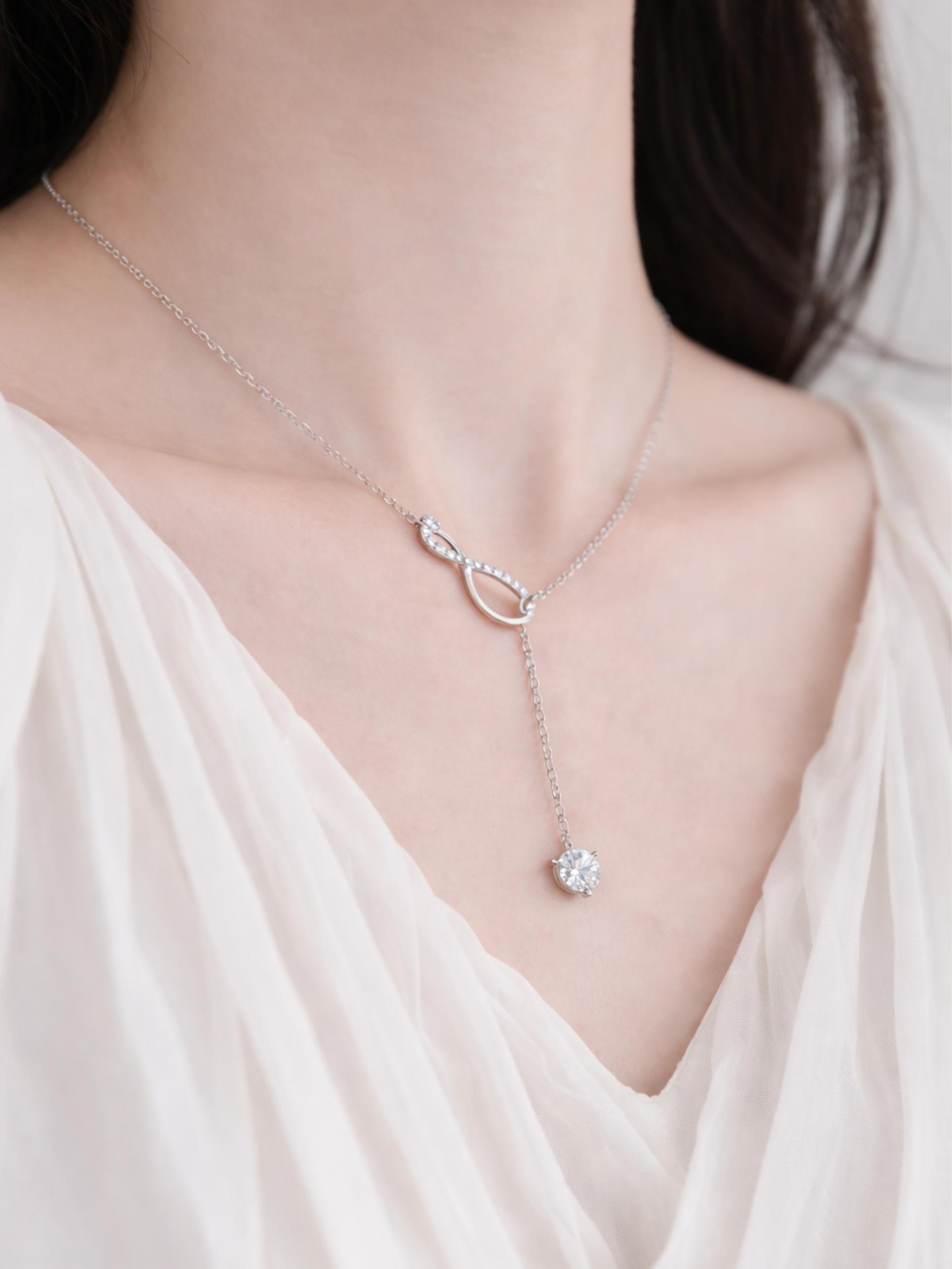Close-up of 6.5mm round moissanite drop stone on Elyra necklace