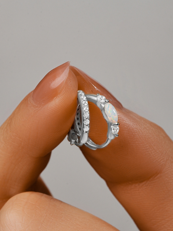 Flat lay of MNML Ferris Two-Way Opal & Stones Single Hoop — 925 silver rhodium minimal jewelry in silver