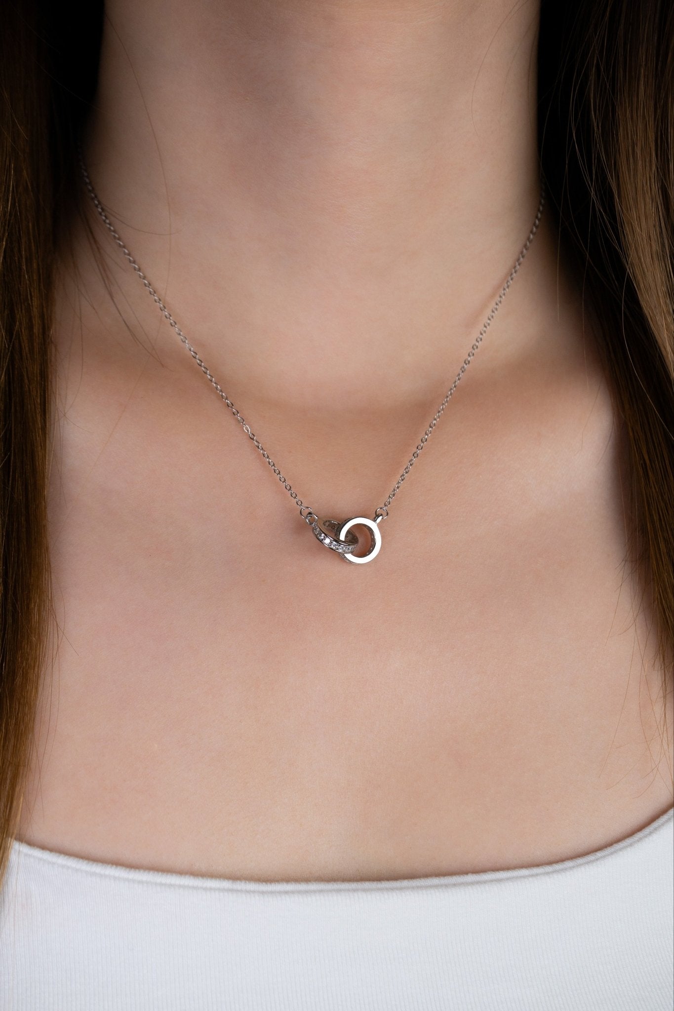 Close-up of interlocking circle pendant on FINLEY necklace