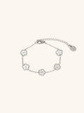 Model wearing MNML Floral Clovers Bracelet in silver on wrist — delicate clover bracelet everyday Malaysia