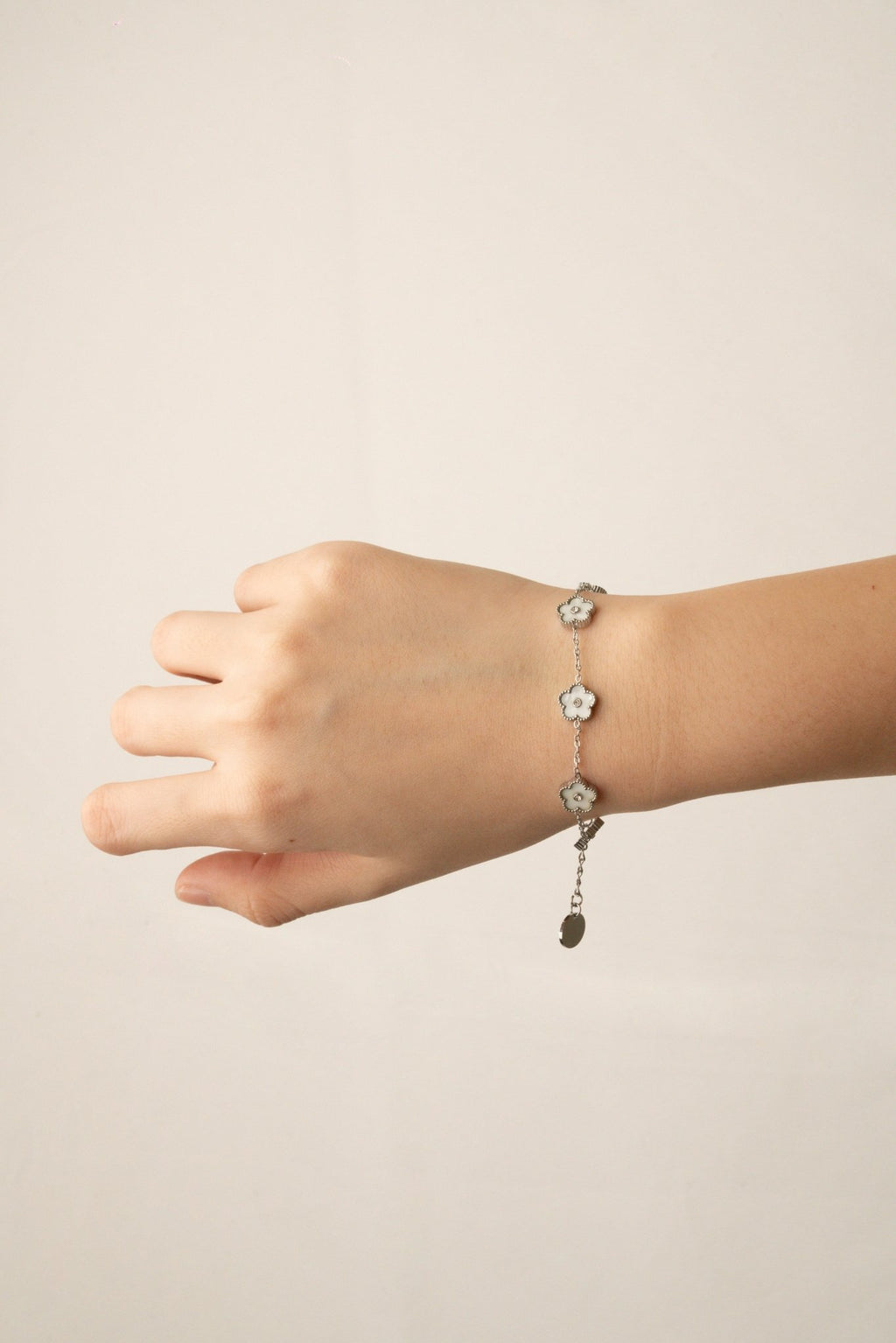 Model wearing MNML Floral Clovers Bracelet on wrist — delicate clover bracelet everyday Malaysia in silver
